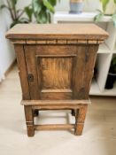An early 20th century oak single door low cupboard,