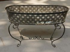 A painted wrought metal planter,
