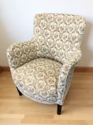 A 20th century armchair in buttoned floral fabric.