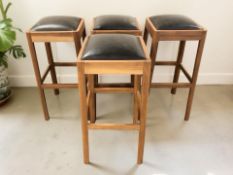 A set of four bar chairs with black vinyl seats, height 81 cm.