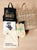 A wicker step basket containing a Radley cloth shoulder bag and several other bags.