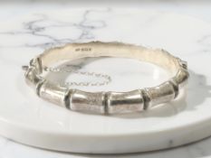 A silver bangle in the form of bamboo, inner width 6cm CONDITION REPORT: 15.