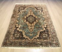 A 20th century machine made carpet of Iranian design, 306 cm x 202 cm.