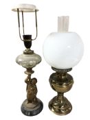 A continental figural oil lamp (converted) and a further Duplex oil lamp with opaque shade.