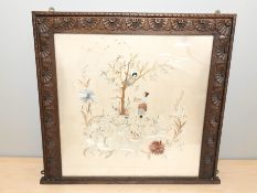 A silk needlework panel in decorative carved oak frame, 71 cm x 64 cm.