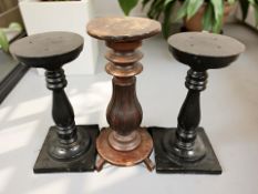 A pair of ebonised plant stands and a turned beech stand,