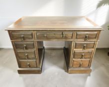 An early 20th century mahogany nine drawer twin pedestal knee hole writing desk,