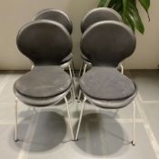 A set of four black vinyl chairs on chrome legs.