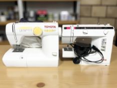 A Toyota electric sewing machine and an Elna sewing machine.