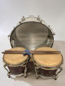 A Weather King drum, a further pair of hide covered drums and a pair of drum sticks.