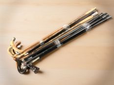 Two bundles of antique and modern walking sticks.