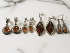 Four pairs of silver and amber earrings