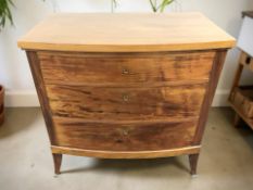 An early 20th century continental walnut bow-front three drawer chest,
