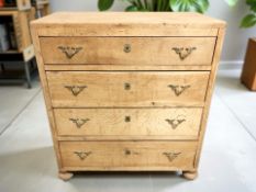 An early 20th century continental oak four drawer chest raised on bun feet,