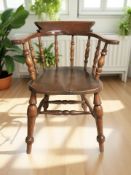 A 19th century elm elbow chair, width 64 cm.