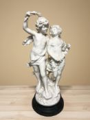 After Auguste Moreau : A plaster group of a boy and girl on turned ebonised sockle stand,
