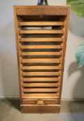 A 1920's oak tambour front office pedestal filing cabinet, fitted twelve drawers internally,