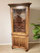 A continental mahogany glazed corner cabinet,