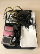 A group of electricals including a pair of Apple Airpods, Tomtom satnav, etc.