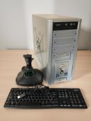 A desktop computer, together with a Logitech keyboard and a gaming joystick.