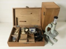 A Regent microscope and a further microscope, both in cases with glass slides, etc.