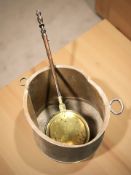 A large 19th century copper twin handled vessel, width 65 cm (misshapen),