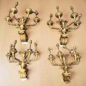 A set of four late 19th century gilt metal four branch wall sconces wired for electricity,