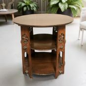 An Arts and Crafts three tier stained wooden occasional table, width 64 cm.