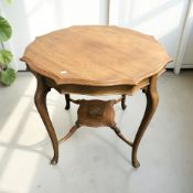 A late Victorian walnut scalloped edge occasional table, height 73 cm.