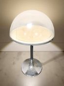 A chrome and perspex domed topped display stand,