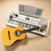 A Yamaha PSR-290 digital keyboard, together with a Herald acoustic guitar.