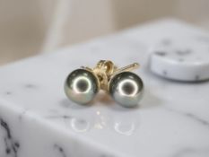 A pair of cultured pearl ear studs with post fittings,
