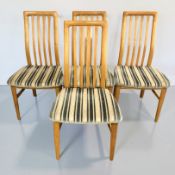A set of four Scandinavian blonde oak dining chairs.