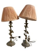 A pair of early 20th century gilt metal table lamps, with shades, height 70 cm.