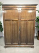 A mahogany compactum wardrobe retailed by Gullachsen & Son Limited, House Furnishers,