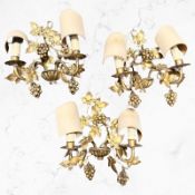 A set of three late 19th century gilt metal twin branch wall sconces wired for electricity,