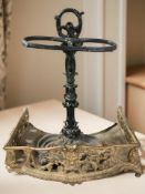 A painted cast iron umbrella stand and a gilt metal fire insert, width 53 cm.