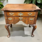 A George III walnut lowboy, fitted four drawers with brass bow handles and escutcheons,