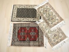 Four various middle eastern mats, largest 67 cm x 40 cm.