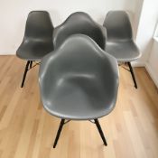 Two pairs of Vitra Eames moulded plastic chairs.