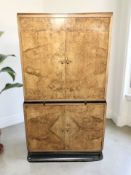 An Art Deco figured walnut and ebonised cocktail cabinet, 96 cm x 59 cm x 168 cm.