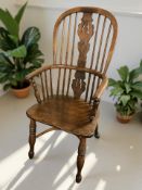 A 19th century elm spindle back chair with crinoline under stretcher, width 54 cm.