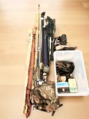 A group of fishing equipment including several rods, rucksack, etc.