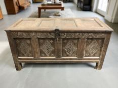 An 18th century carved panelled oak coffer,