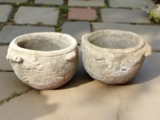 A pair of concrete acanthus leaf twin-handled planters,