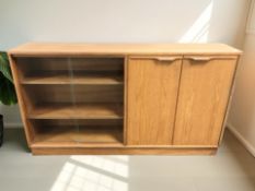 A 1970's teak sliding glass door cabinet,