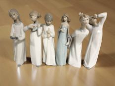Five Lladro / Nao figures of children in night dress and further Lladro figure of a lady,