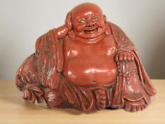 A Chinese red lacquered figure of Buddha,