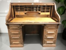A 1920's walnut roll top desk with inset retailer plaque 'The Shannon Limited, Ropemaker Street,