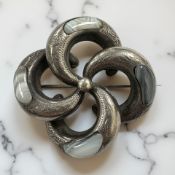 An antique silver and agate brooch,